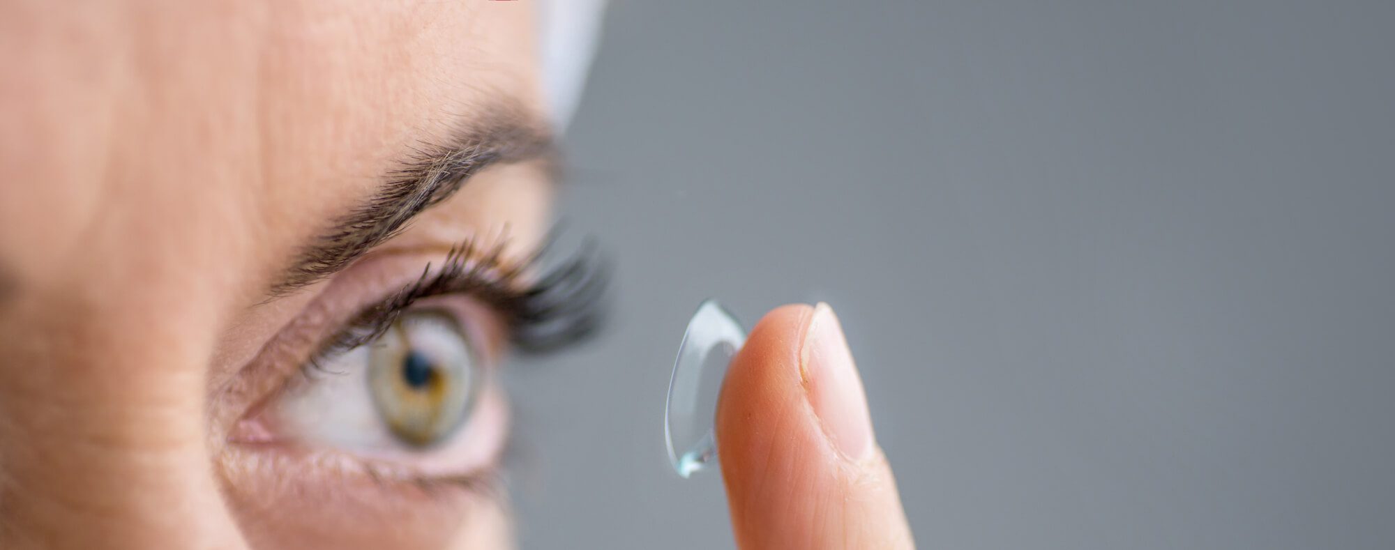 close up of a mature lady putting on contact lenses in her eyes